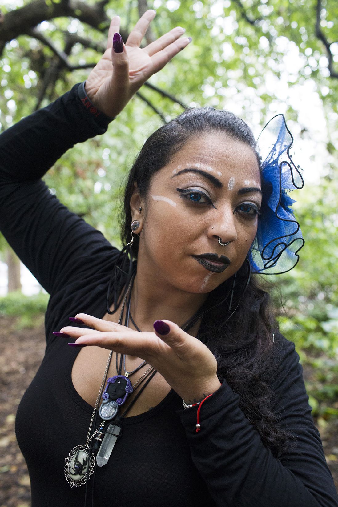 Indigo Delunazv, dancer with Witchmaste a tribal belly dance group which members are all of the Pagan faith, says “I love being a part of this community because it’s a multi faith community where everyone loves each other - no matter what it is, it is all about love… Treat someone the way you want to be treated, everything you put out into the universe will come back to you weather it is good or bad.” Delunazv poses for a portrait in Washington Square Park during the Pagan Pride Festival on Saturday, October 1, 2016.<br>